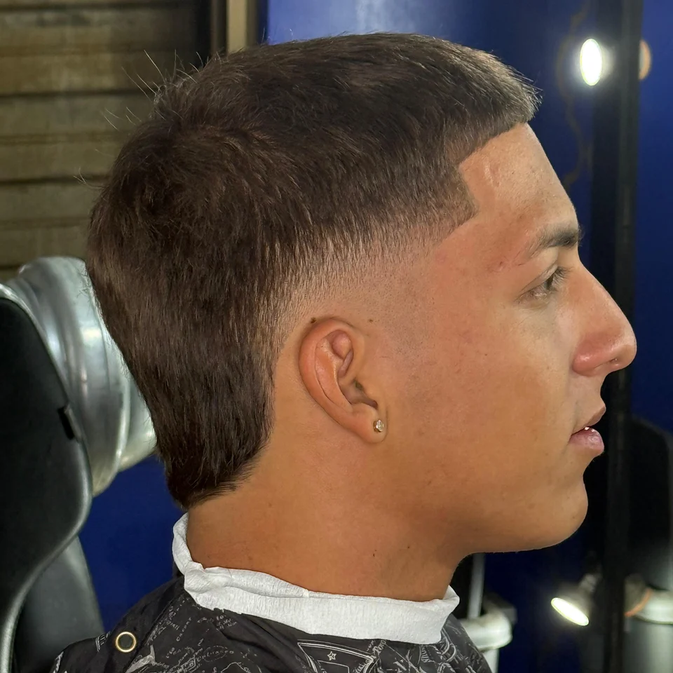 Haircut with a hard part line and clean fade