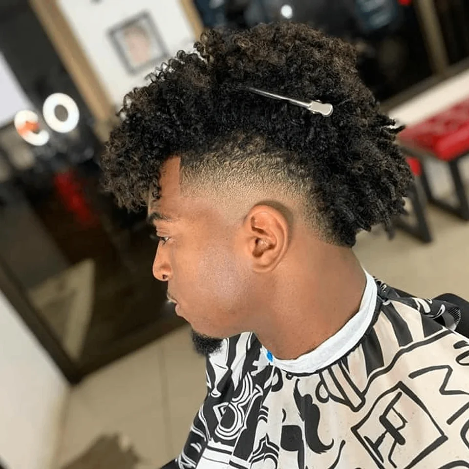 Afro with a high fade and defined contours