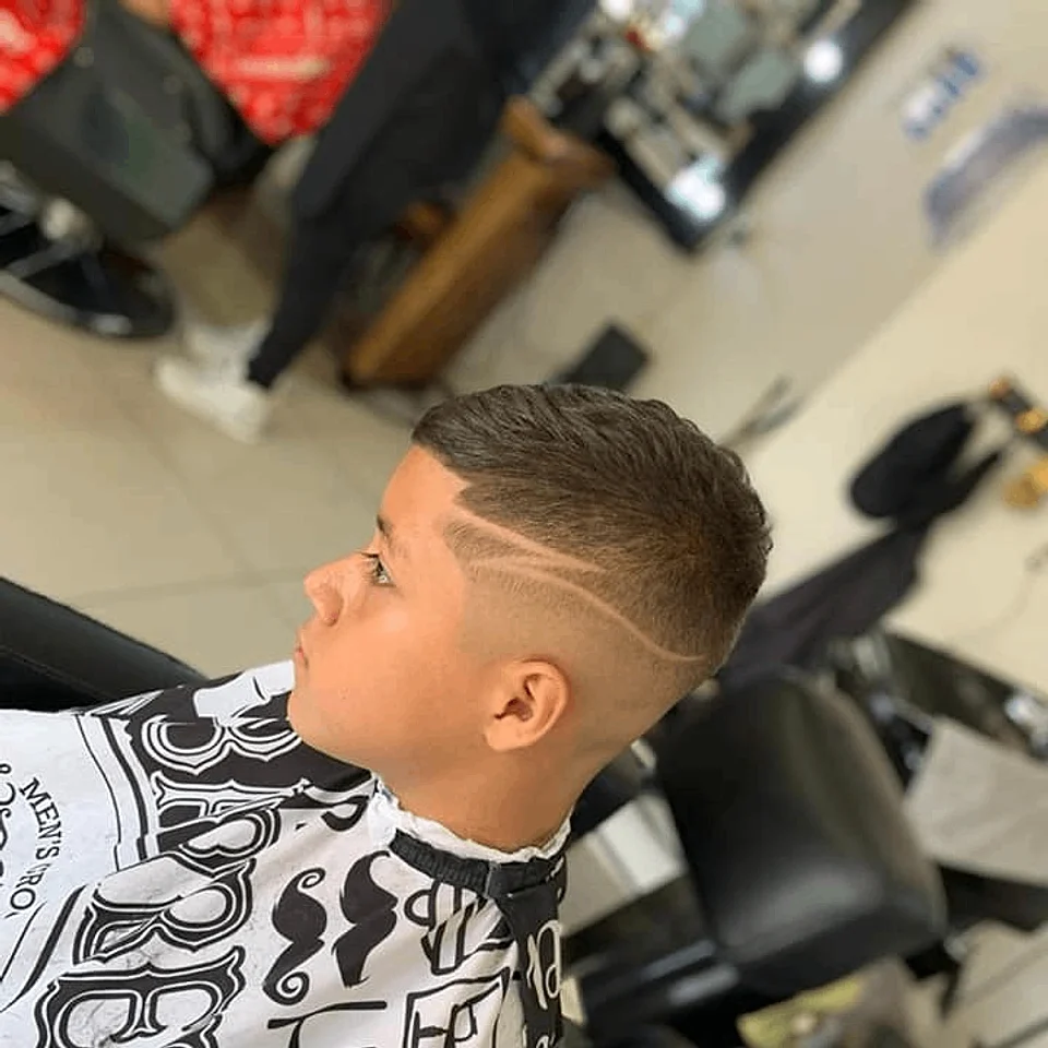 Children’s haircut with a side design line