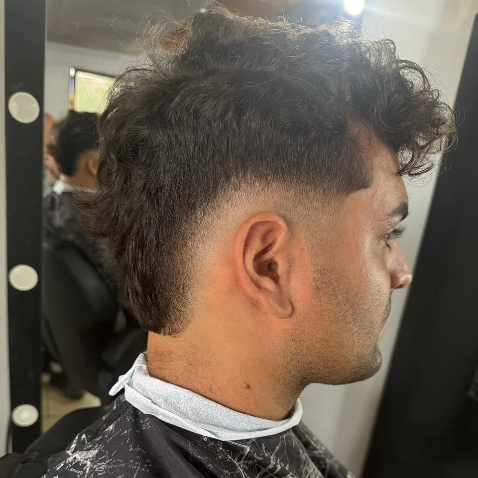 Curly mullet with a clean fade on the sides
